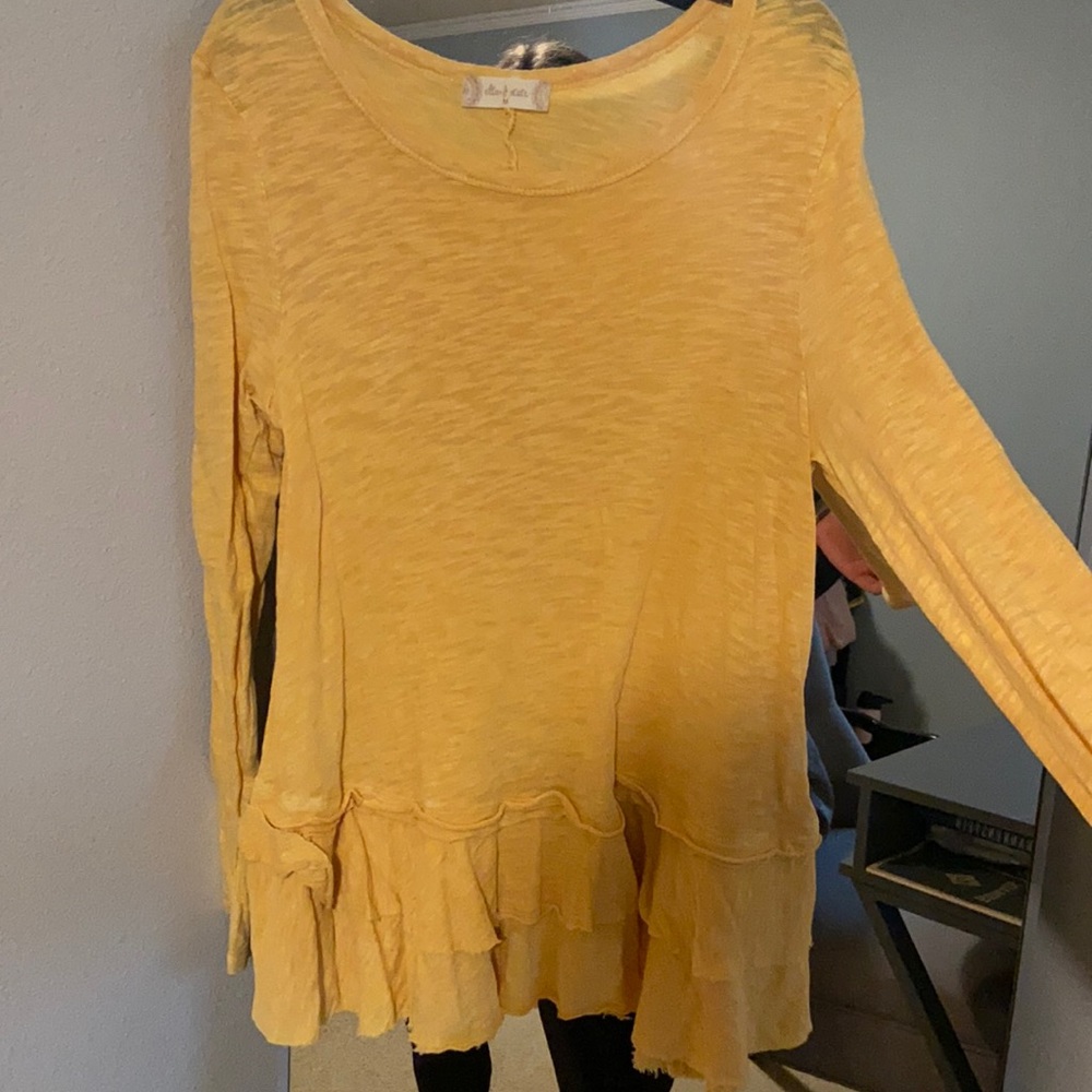 Yellow ruffled top.